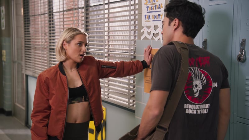 A girl confronting a boy in a school hallway lined with lockers