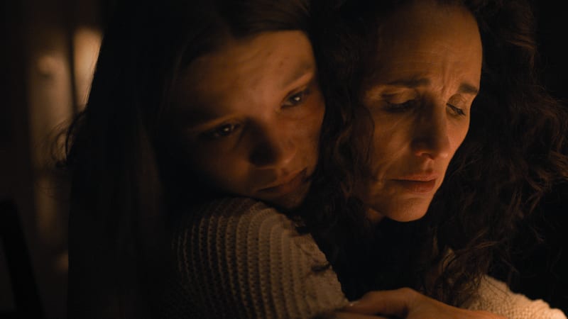 Jane embracing her mother in a dim room