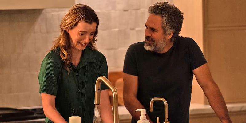 Harper and their dad smiling at the kitchen sink
