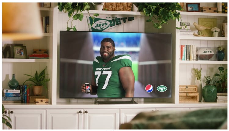 A New York Jets player on a TV screen in a family living room