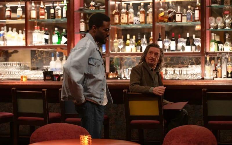 Two men talking at a bar